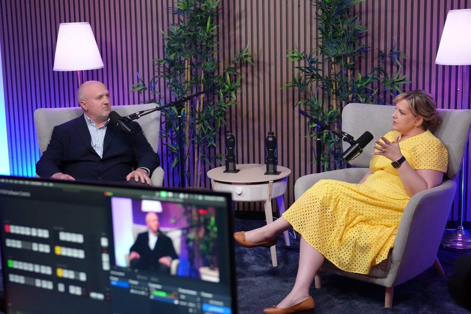 Man and woman in armchairs in an interview setting