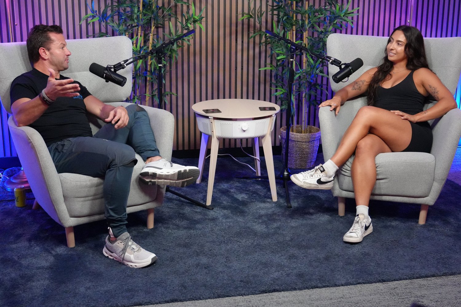 Man and woman in armchairs recording a podcast
